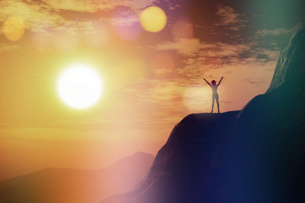 3D render of a female with arms raised on a cliff against a sunset sky